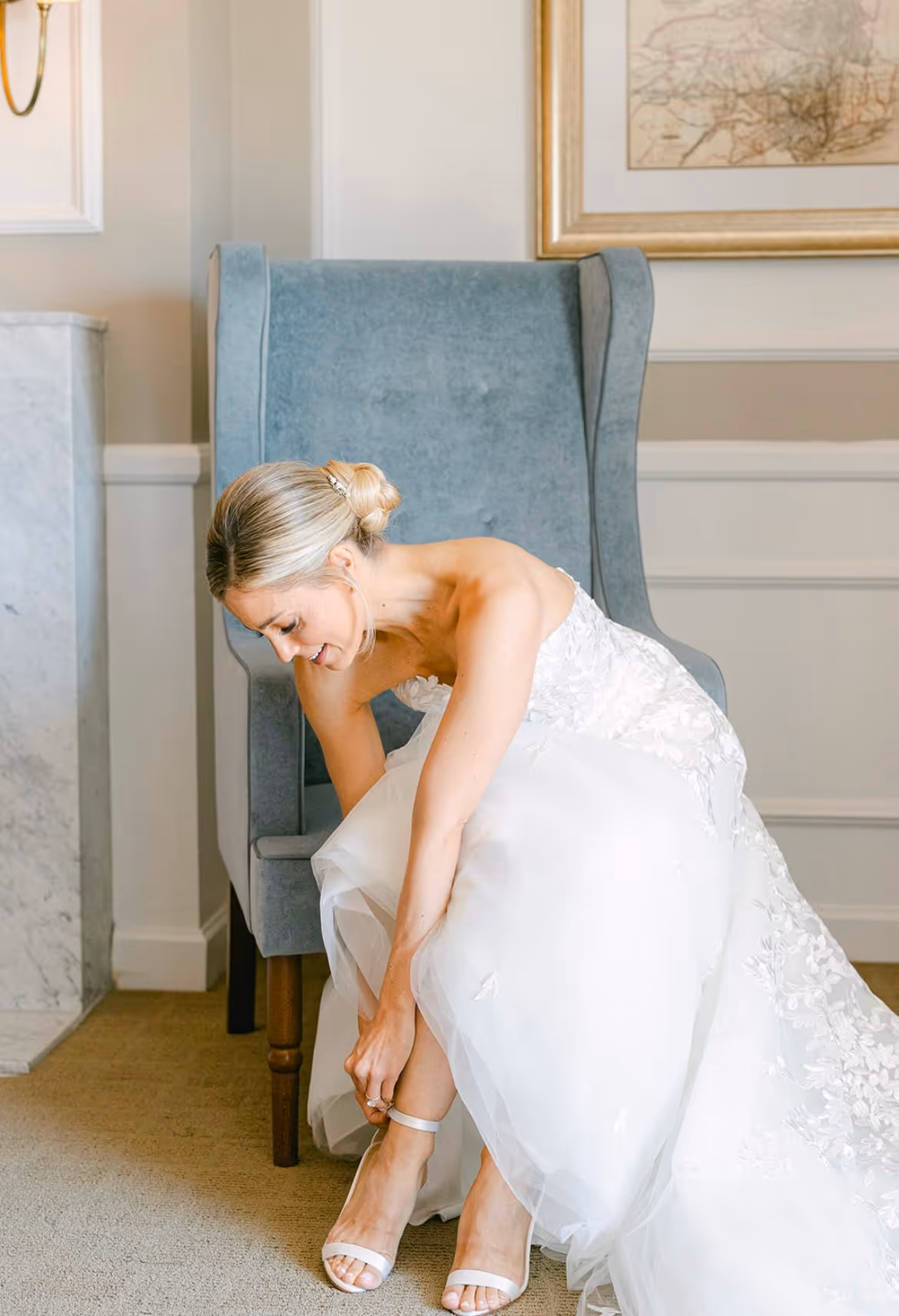 Pre-cereemony photo of a bride in their dress with hair styled by Liana