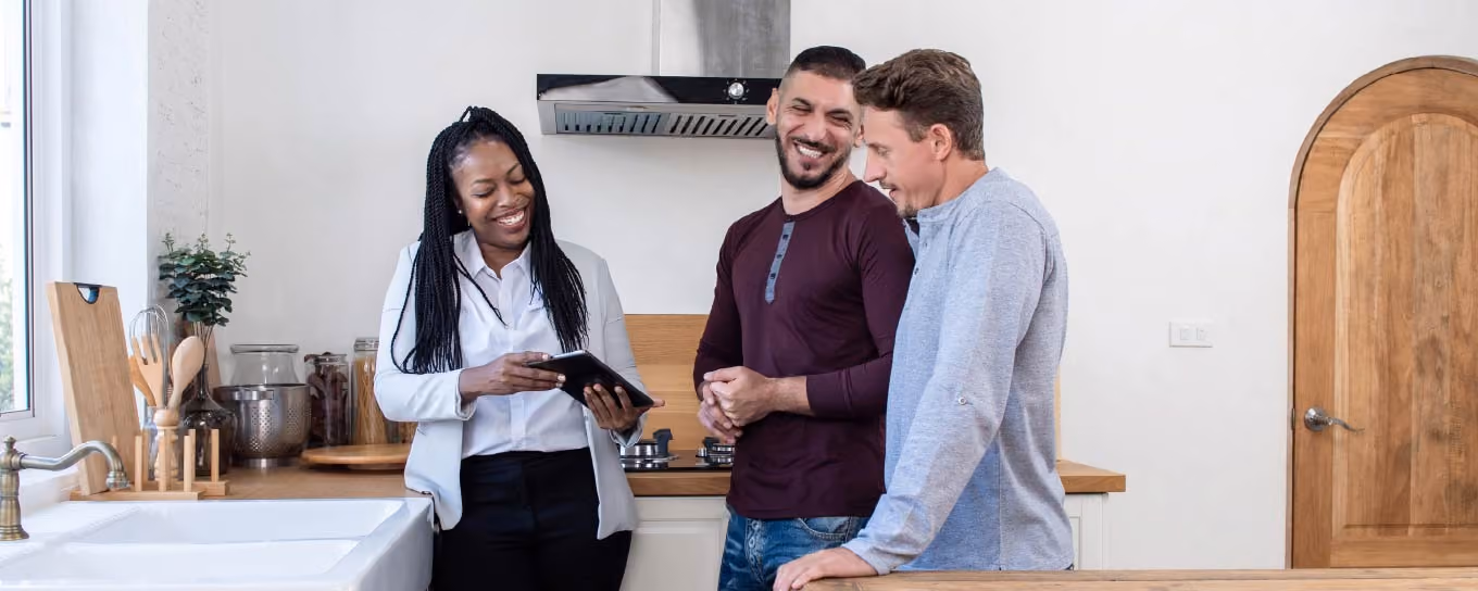 real estate agent talking to two home buyers