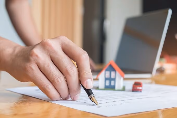 Man signing a contract with his pen|Magnifying glass on a legal contract