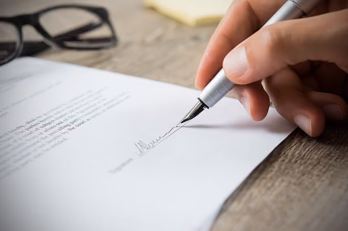 Man signing a rental application contract