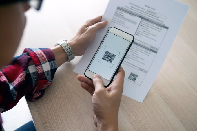 Man reviewing tenant screening report with QR code