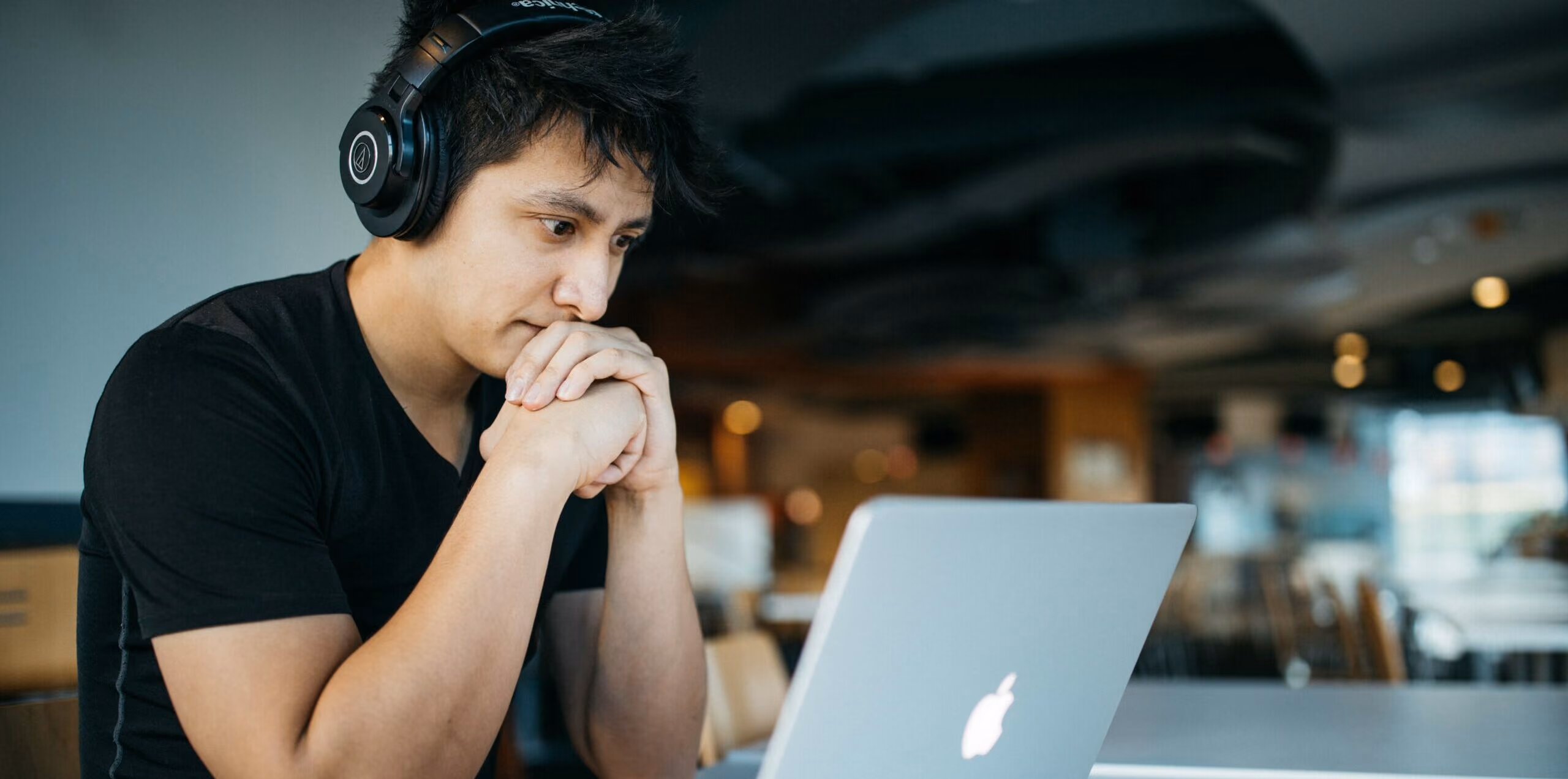 man on laptop studying for the real estate exam
