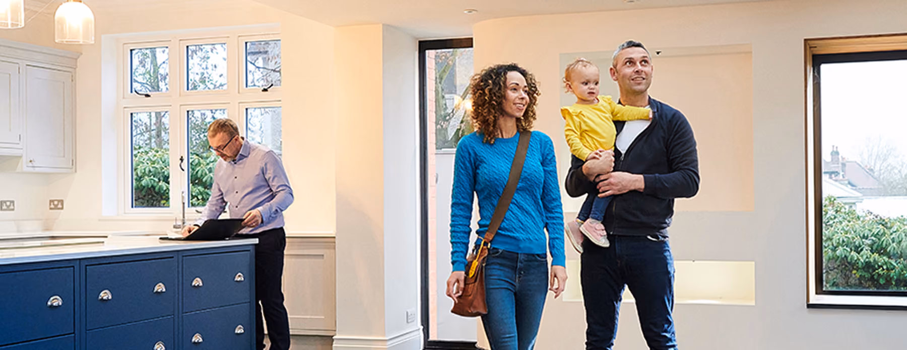 couple-with-baby-touring-new-home