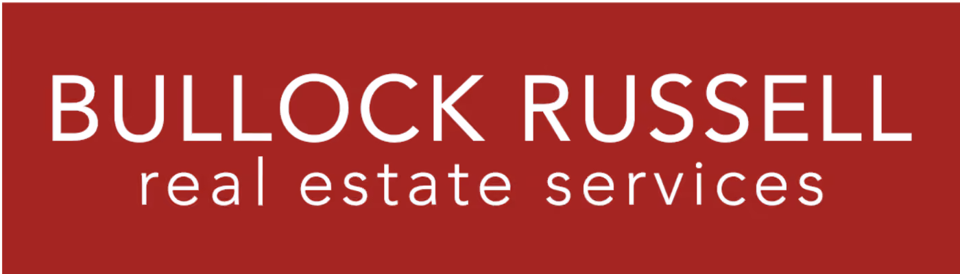 Bullock Russell real estate services logo with white text on a dark red background.
