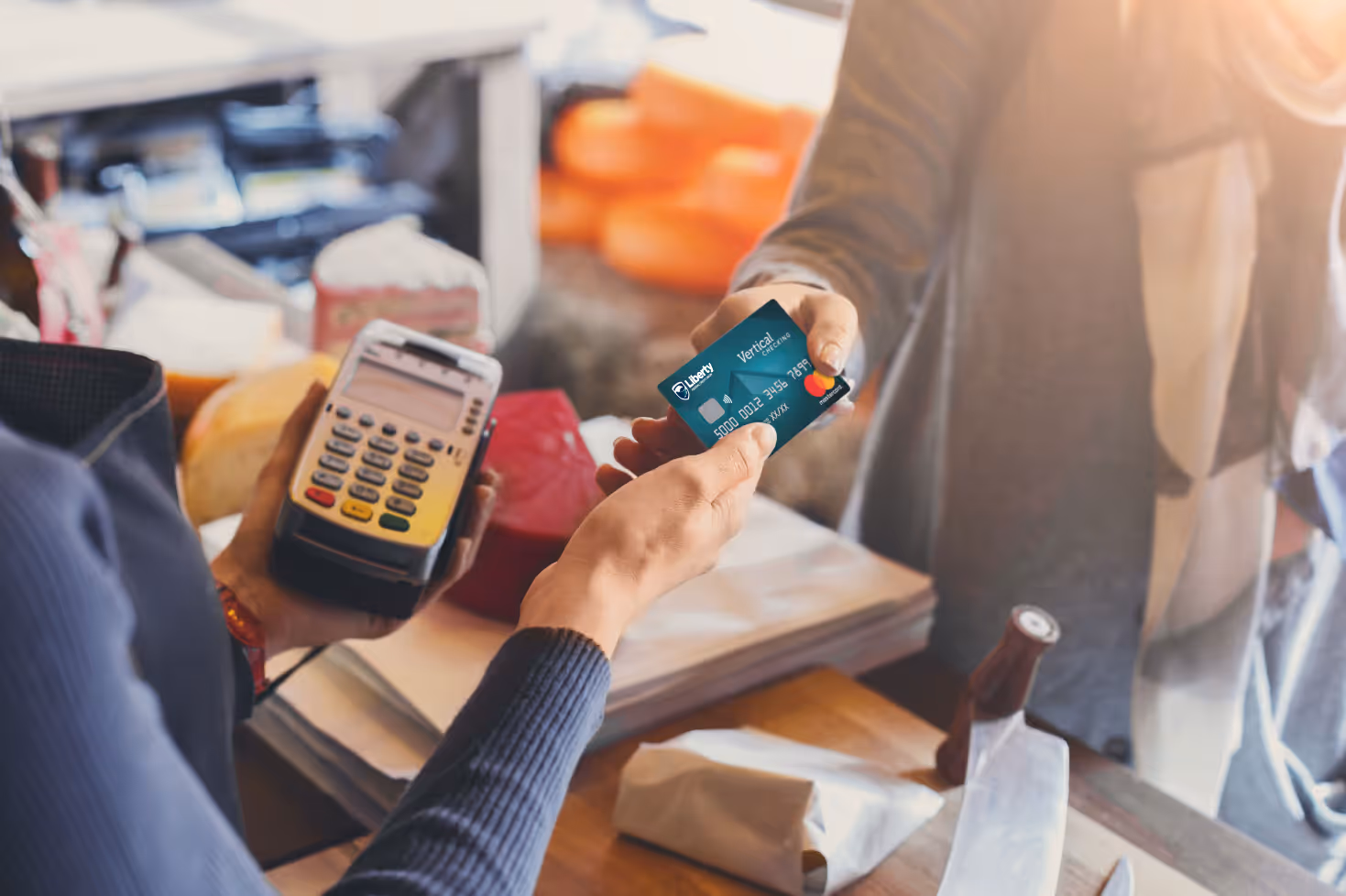 A person holding a cell phone and a credit card.