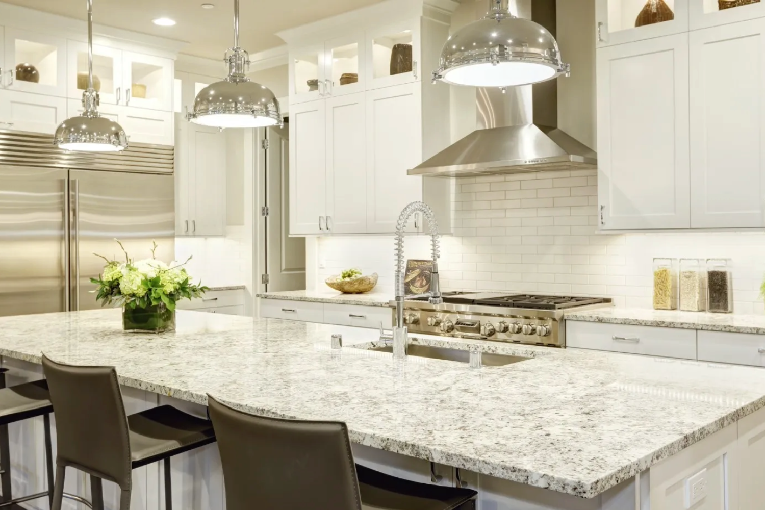 Modern kitchen with white granite countertops.