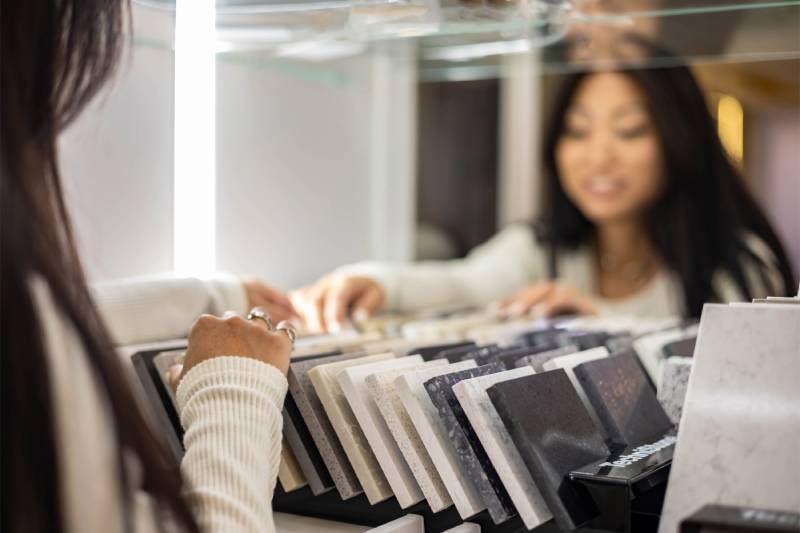 Woman browsing countertop samples.