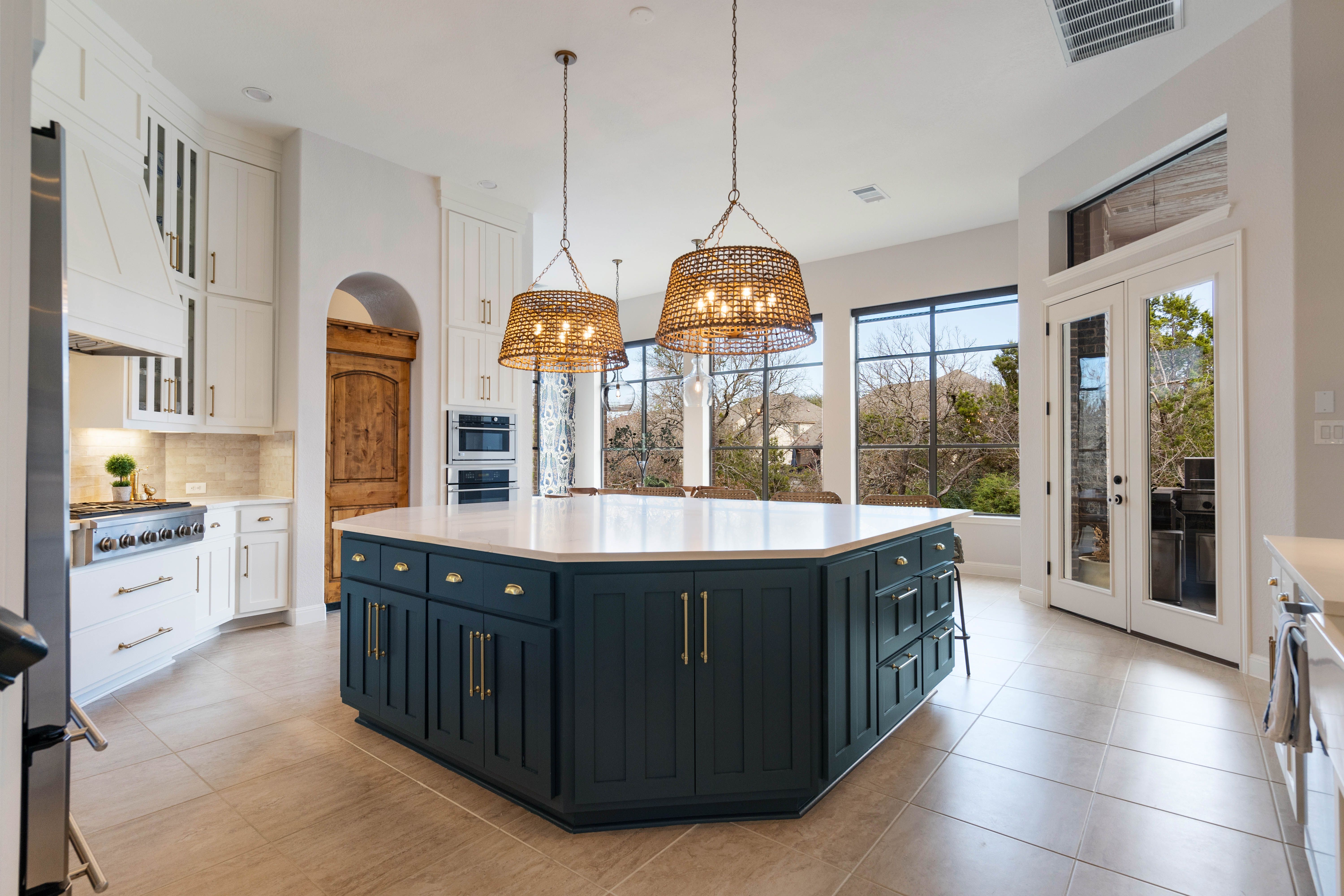 Luxury kitchen with white quartz island and pendant lighting