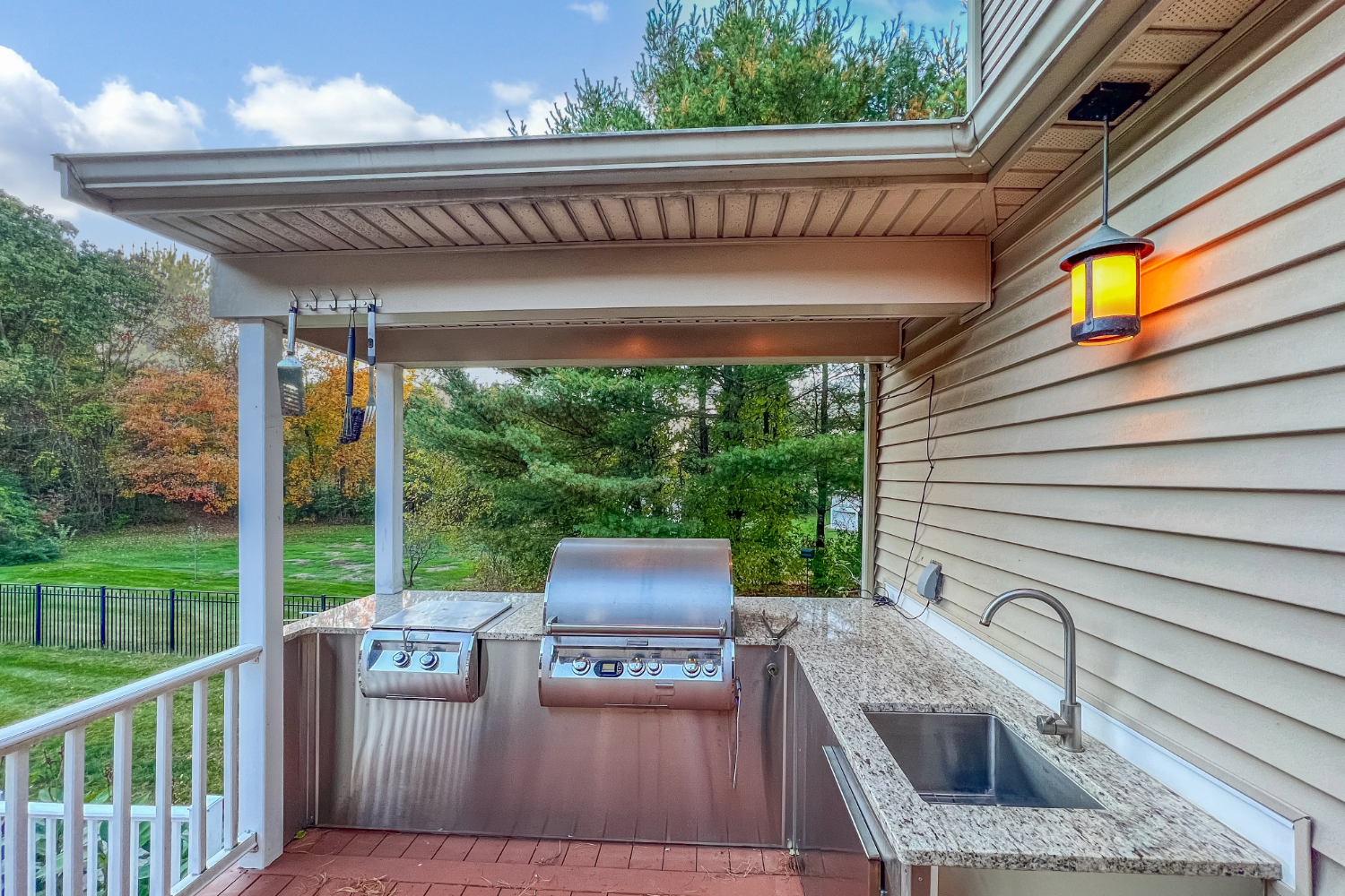 Outdoor kitchen with granite countertops and built-in grill