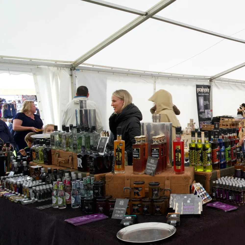 People browsing stalls at an indoor show trade stand