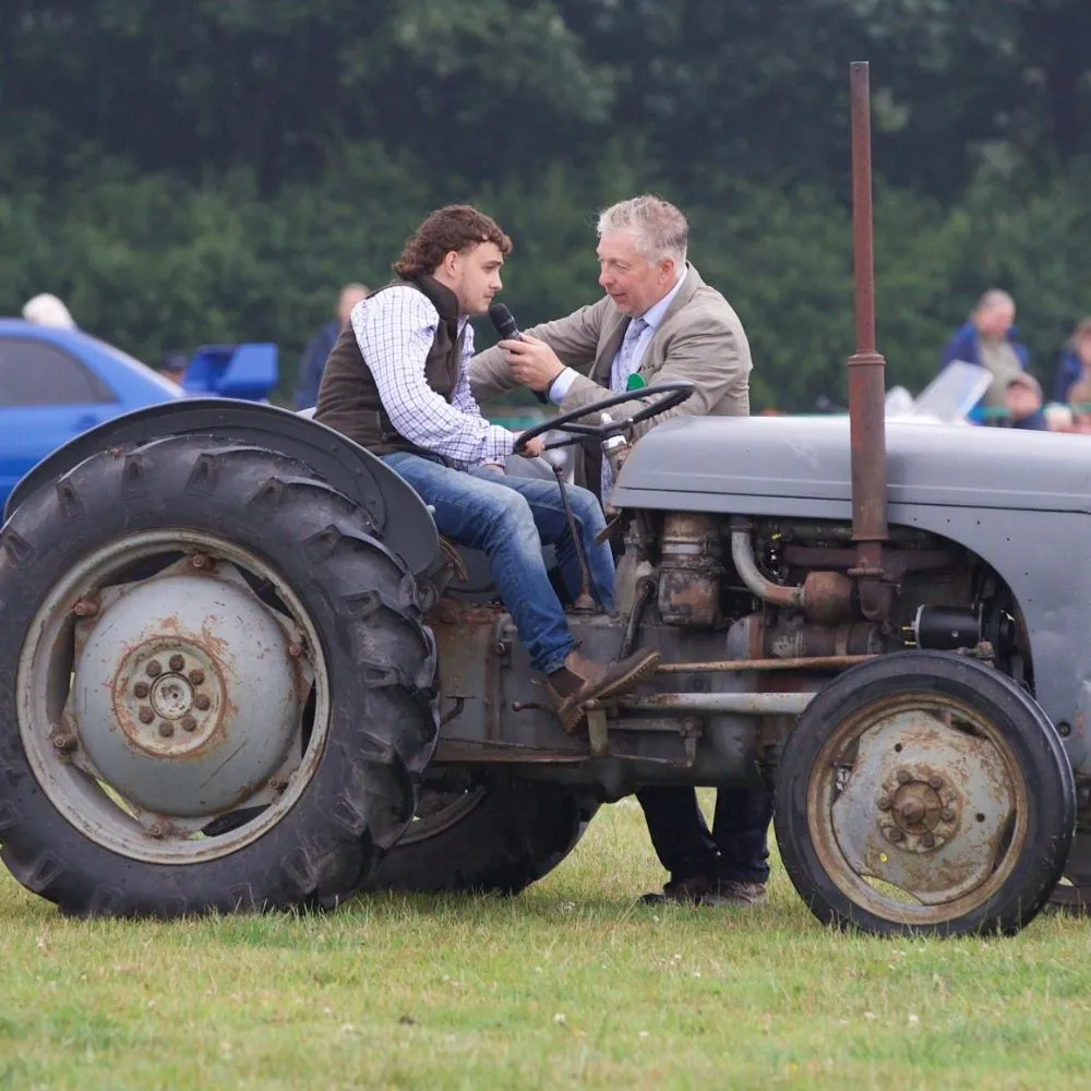 A young man on his tractor getting interviewed.