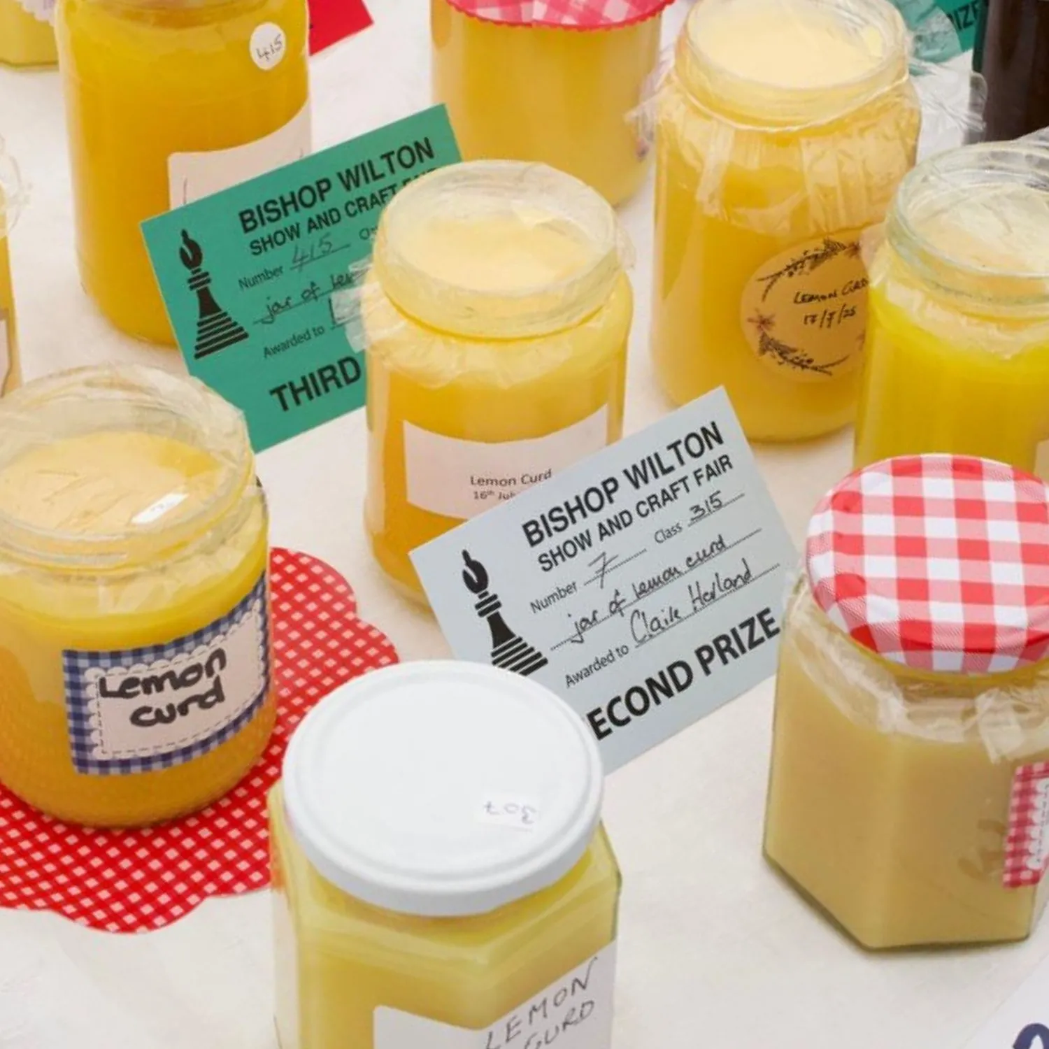 Jars of lemon curd at Bishop Wilton Show and Craft Fair, with prize cards for second and third place.