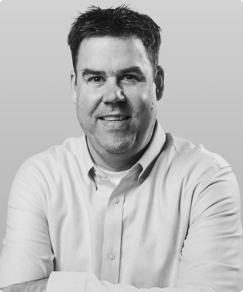A black and white photo of Paul Huck, the co-founder and CTO of Rev.
