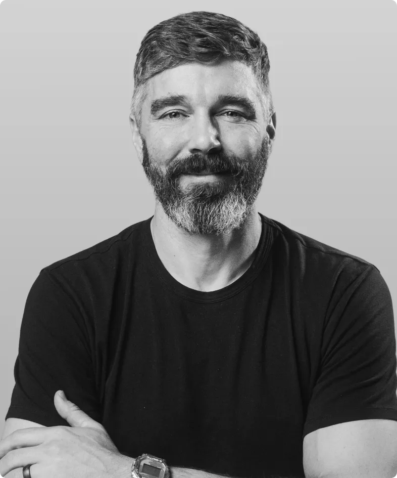 A black and white photo of Jason Chicola, the founder and CEO of Rev.