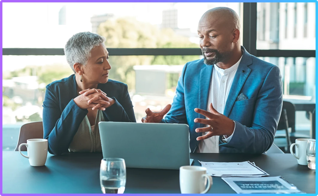 Lawyer reviewing documents with client at table during legal consultation