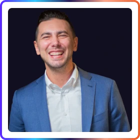 Headshot of a person in casual shirt against blurred outdoor background, professional portrait
