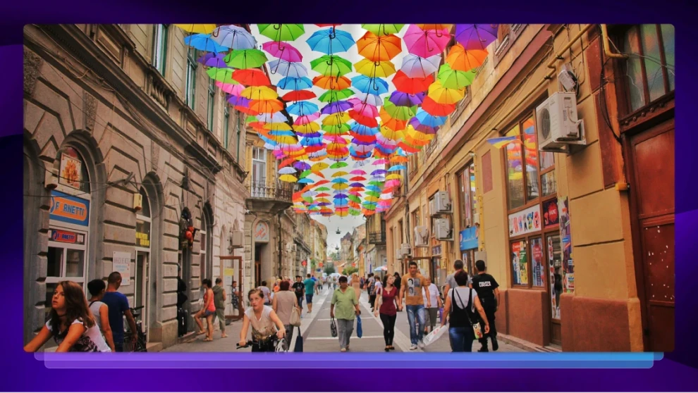 Busy city street with colorful umbrellas overhead, representing global culture and content localization.