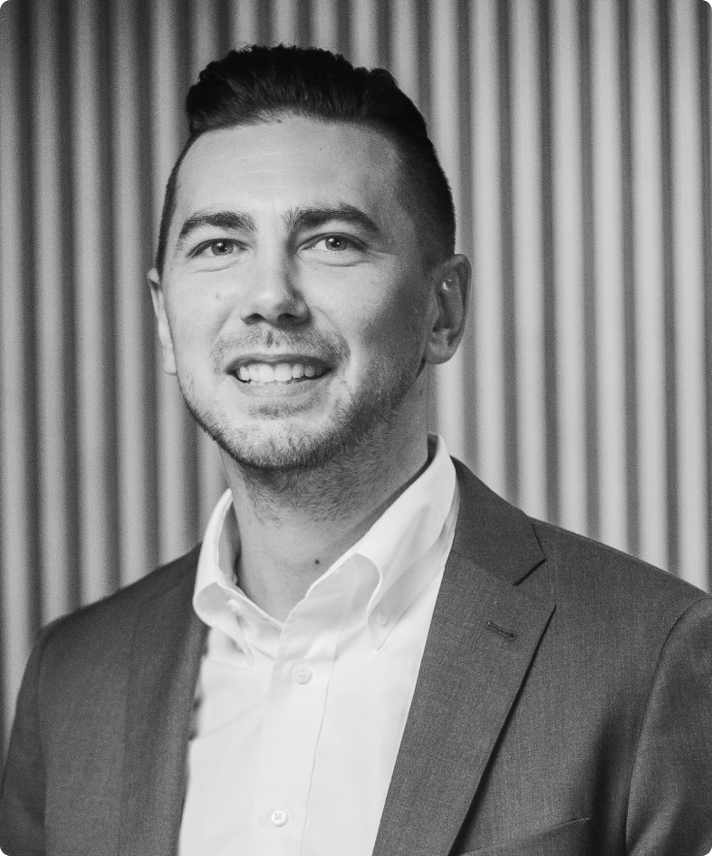 A black and white photo of Miguel Jetté, the VP of AI and R&D for Rev.