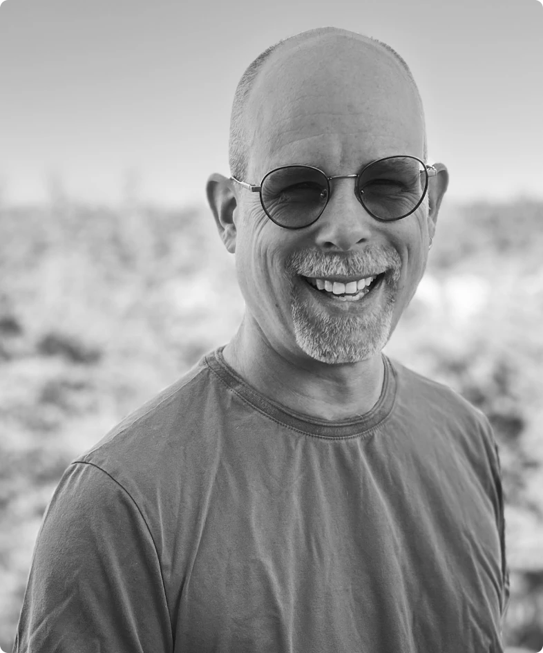 A black and white photo of Miguel Jetté, the VP of AI and R&D for Rev.