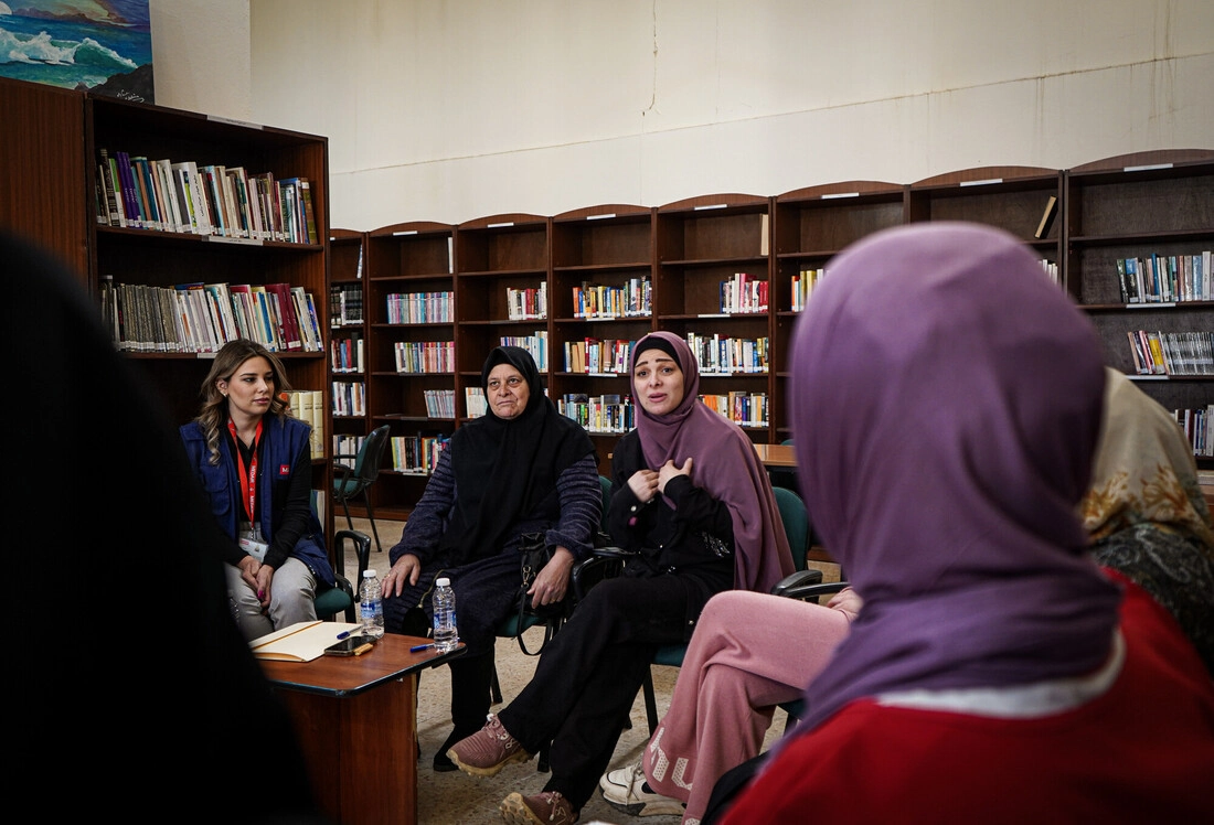 A group of participants gather together for a support group session.