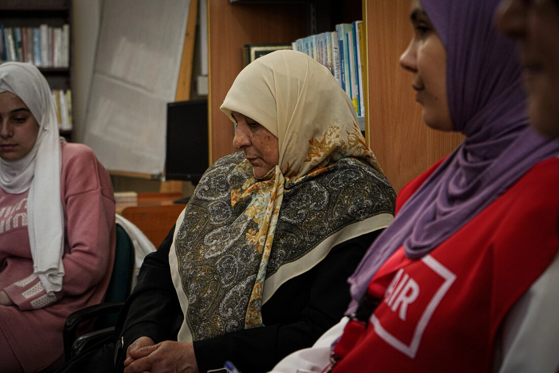  A participant listens intently during a peer support group session.