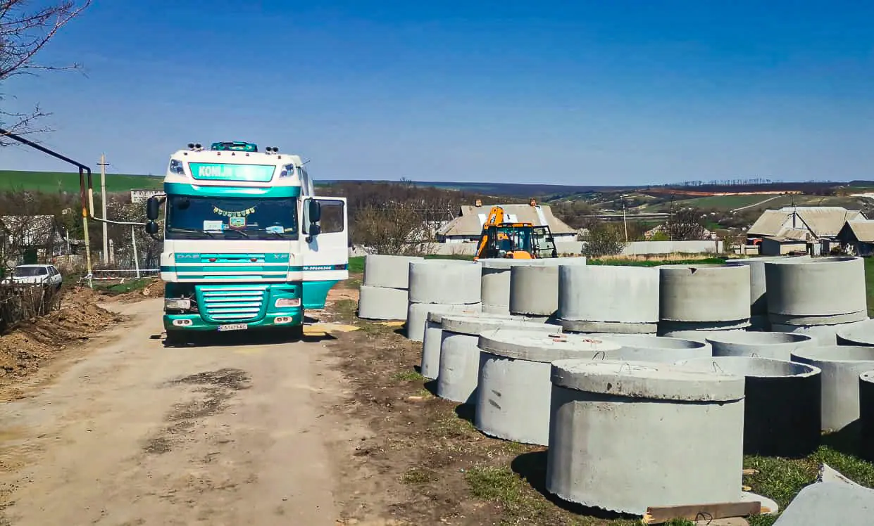 Truck and construction materials for water infrastructure project in rural village.
