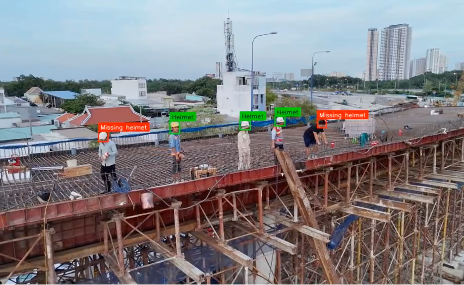 Computer vision system detecting missing helmets among construction workers on a rooftop site.