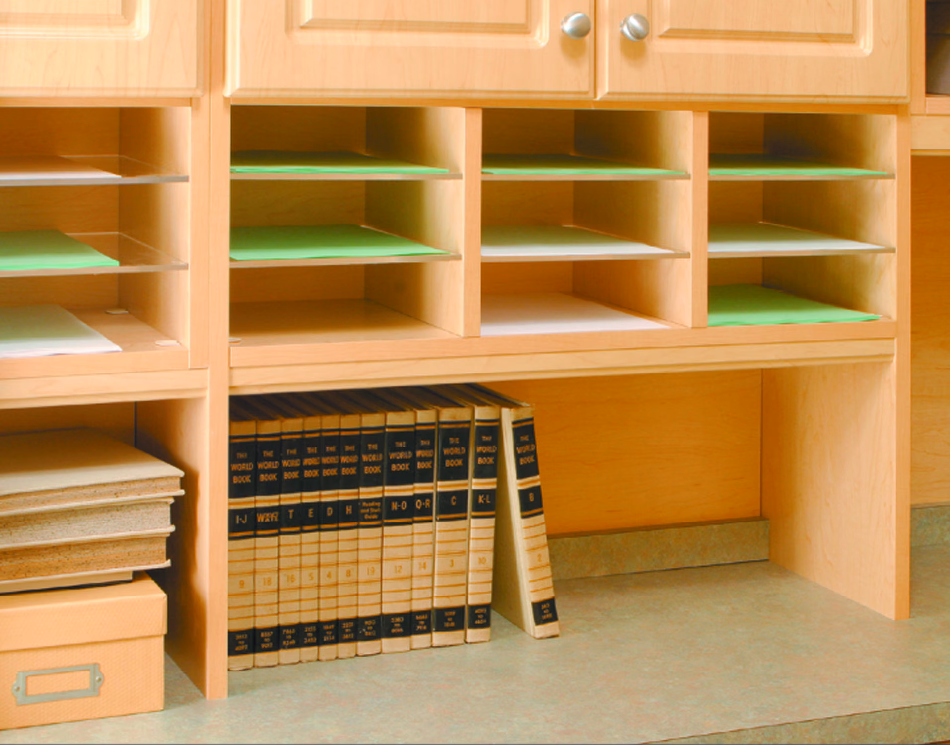 Light wood home office shelving holding archive boxes and stacked files.
