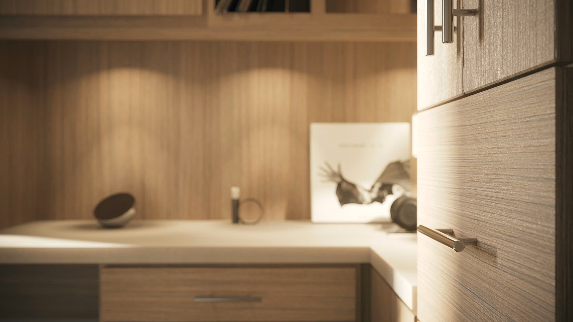 Close-up of a home office desk surface lit by under-cabinet task lighting.