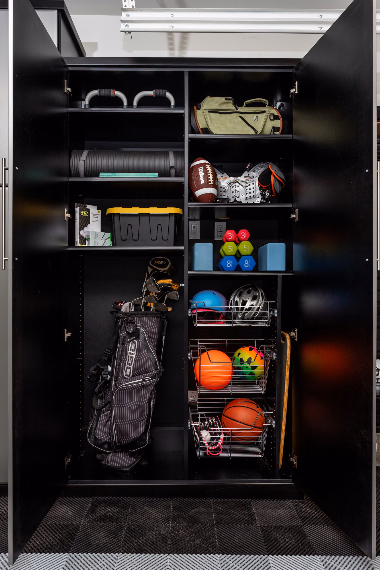 Tall black garage cabinet holding a golf bag, basketballs, and sports gear in open cubbies.