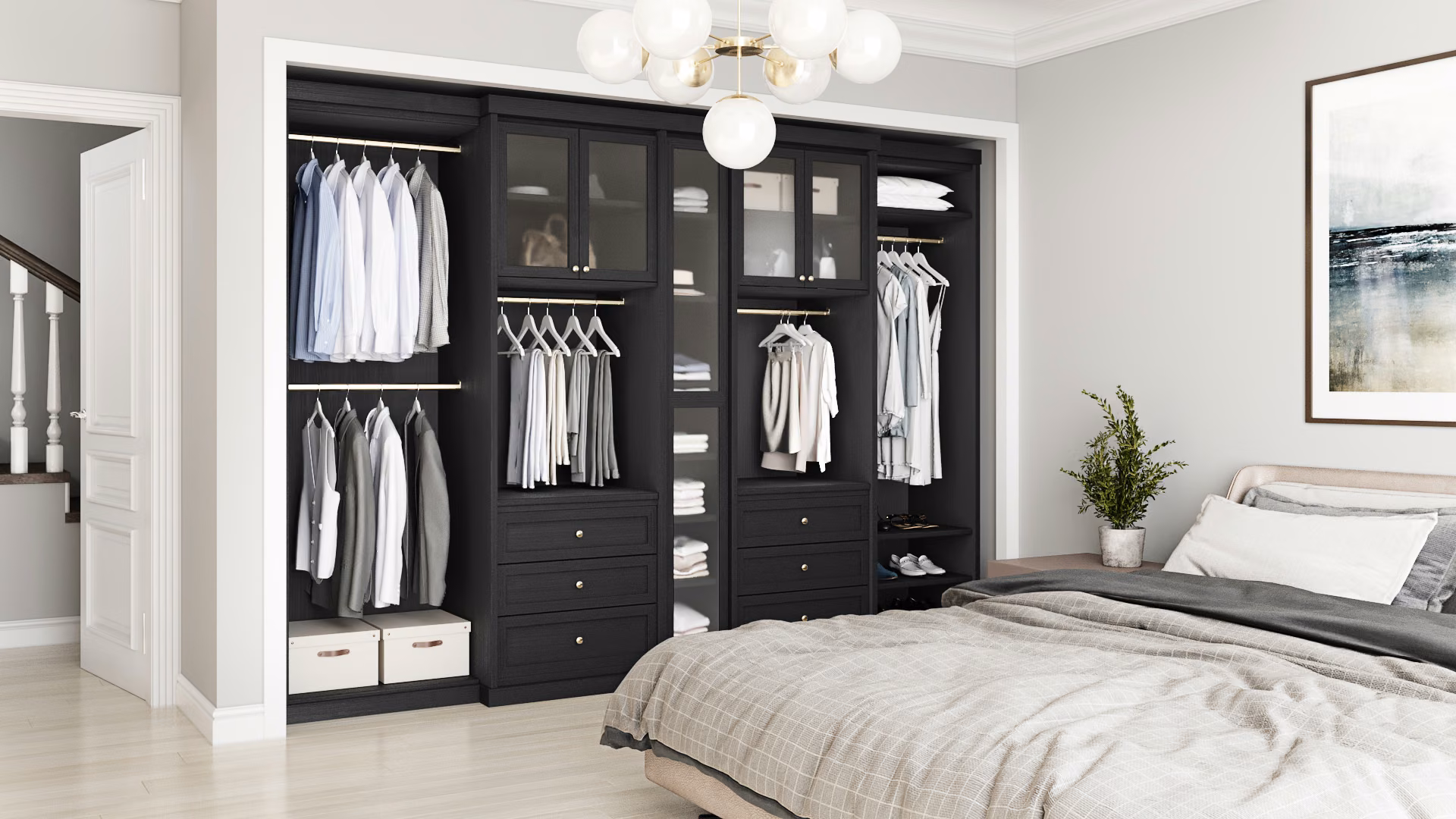 Reach-in bedroom closet with double-hang rods on either side of glass-front cabinet towers.