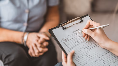 A doctor consults with a patient.