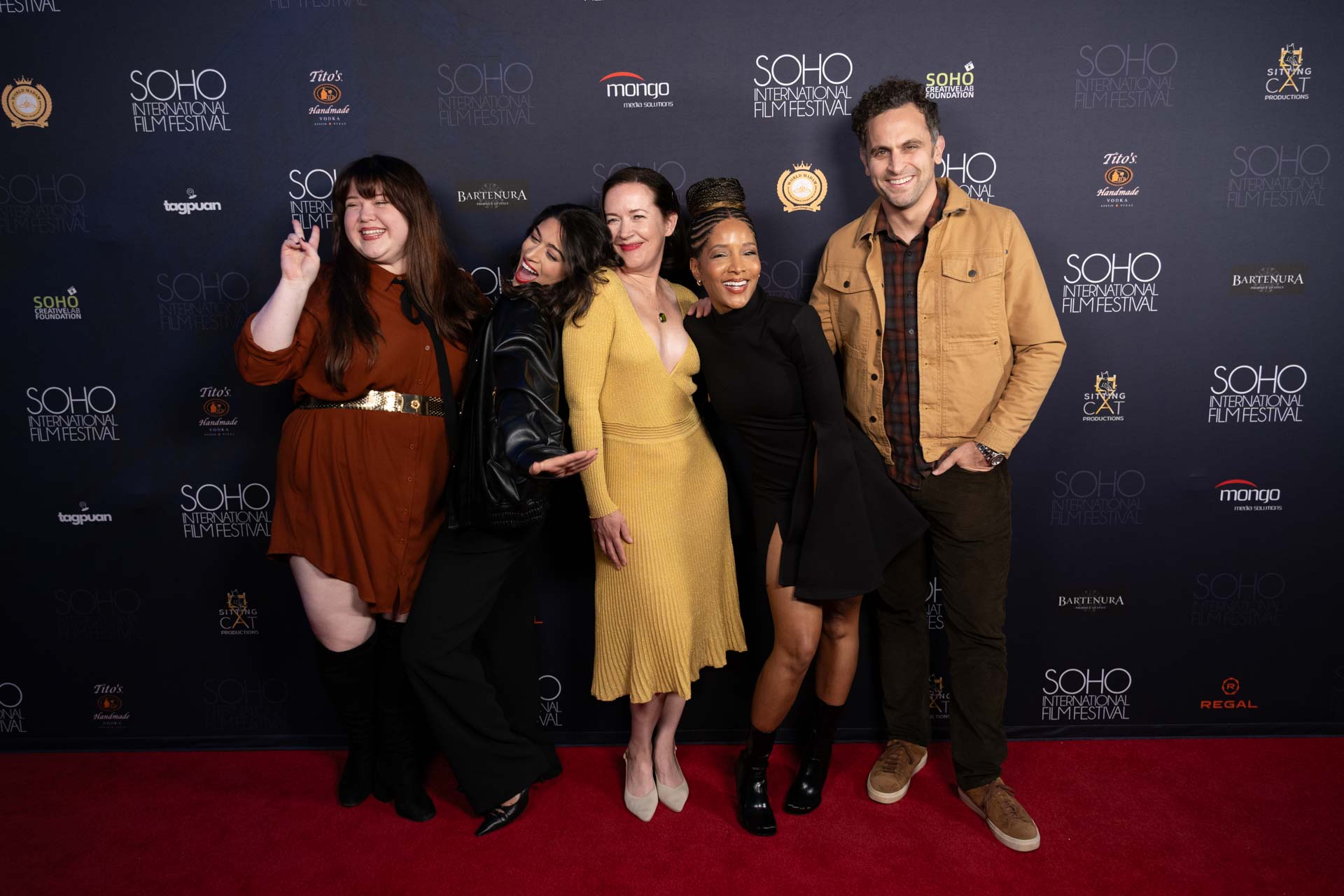 Group of five people posing and smiling on the red carpet at the SOHO International Film Festival.