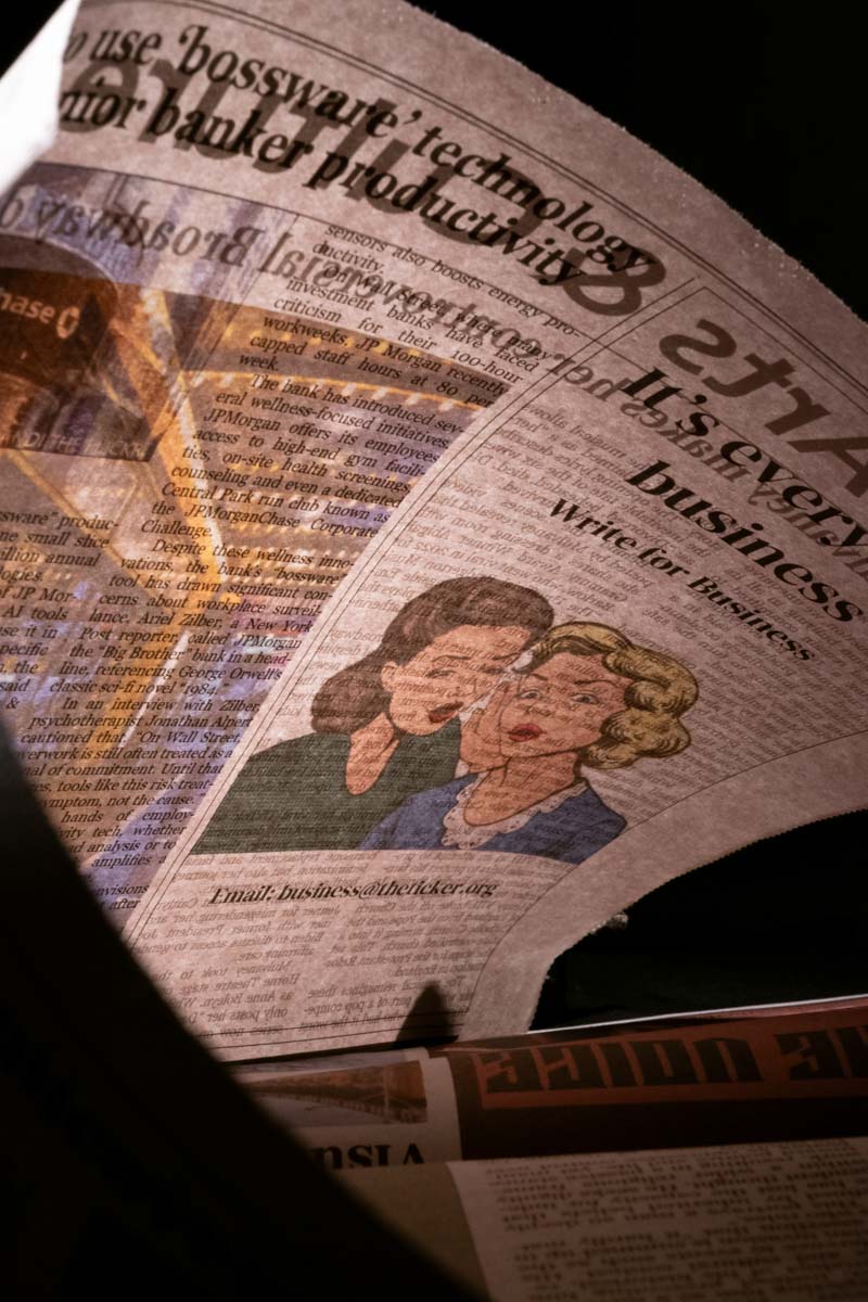 Curved newspaper page showing text, an illustration of two women.