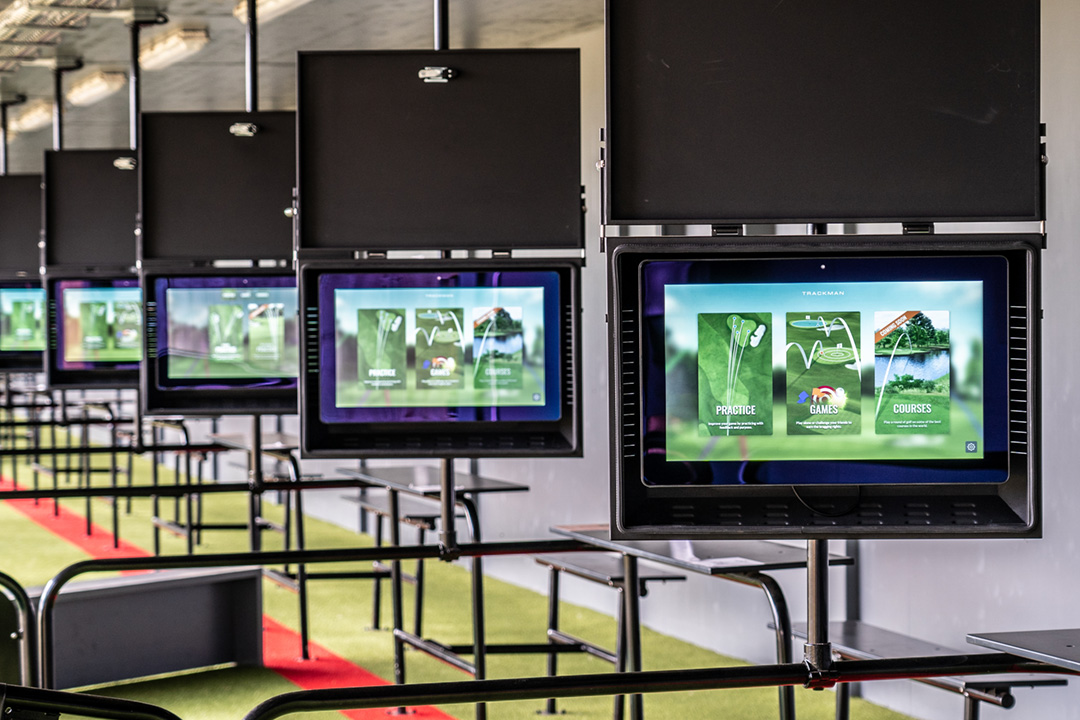 Many golf simulators in integrated bays