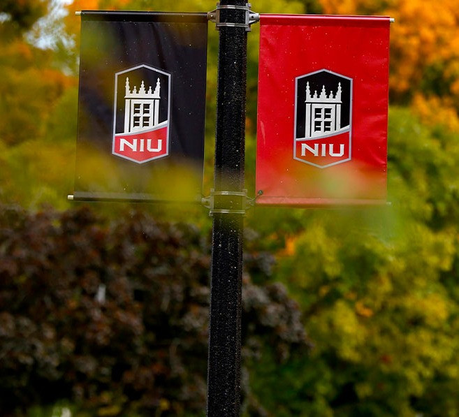 NIU campus banners in fall foliage