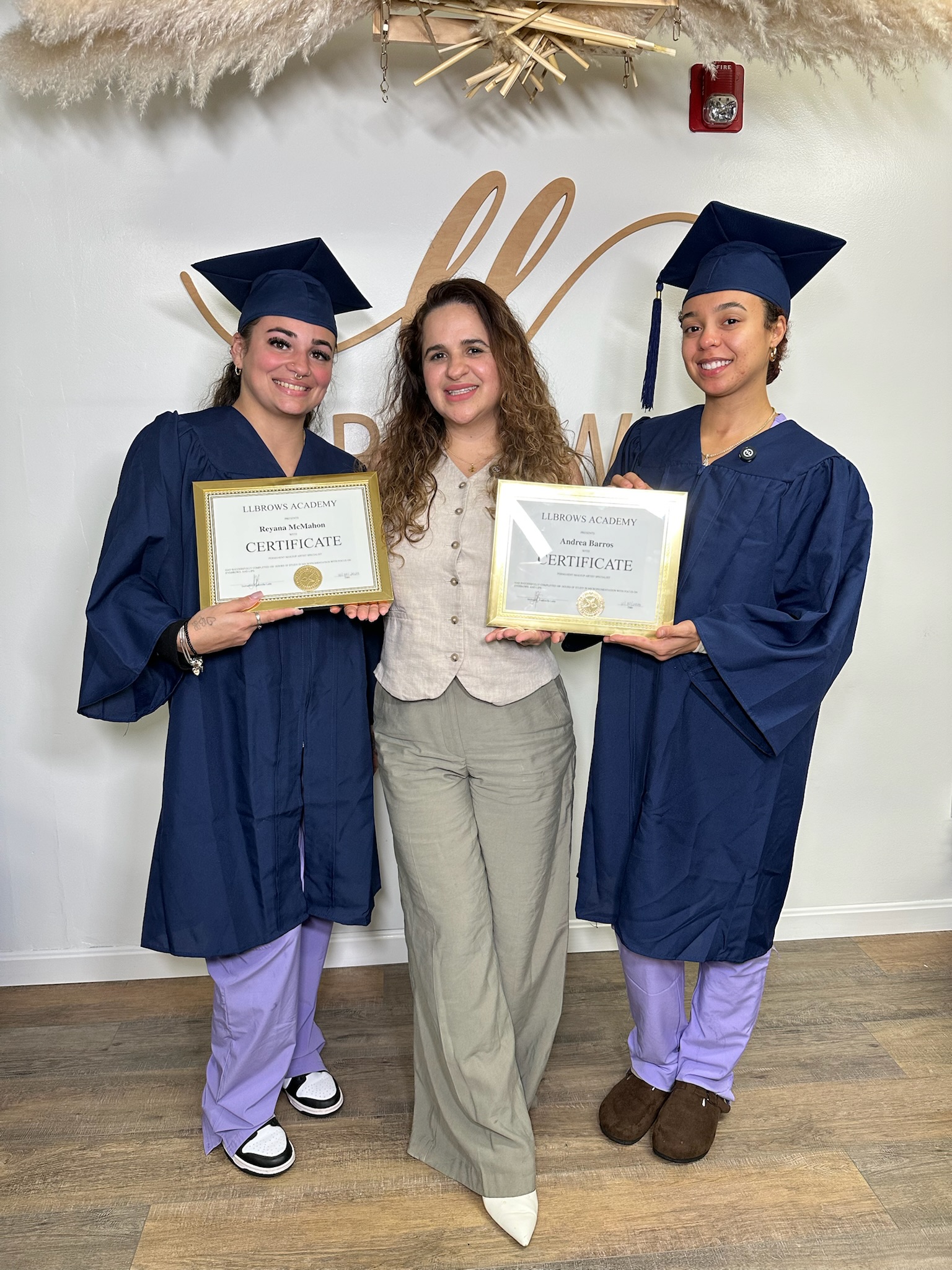 LL Brows Academy students celebrating with instructor