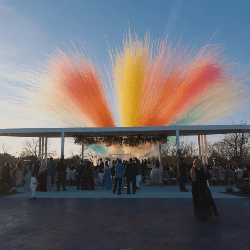 Colourful feather-like installation in red, orange and yellow above the pavilion
