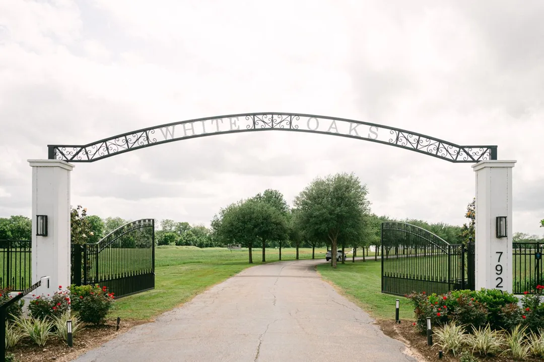 Entrance gate to White Oaks with an iron arch over the drive