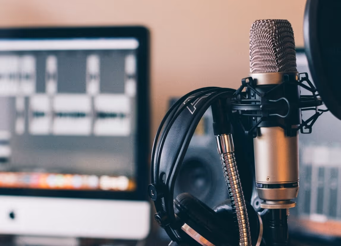 Image of computer and microphone signaling podcast action