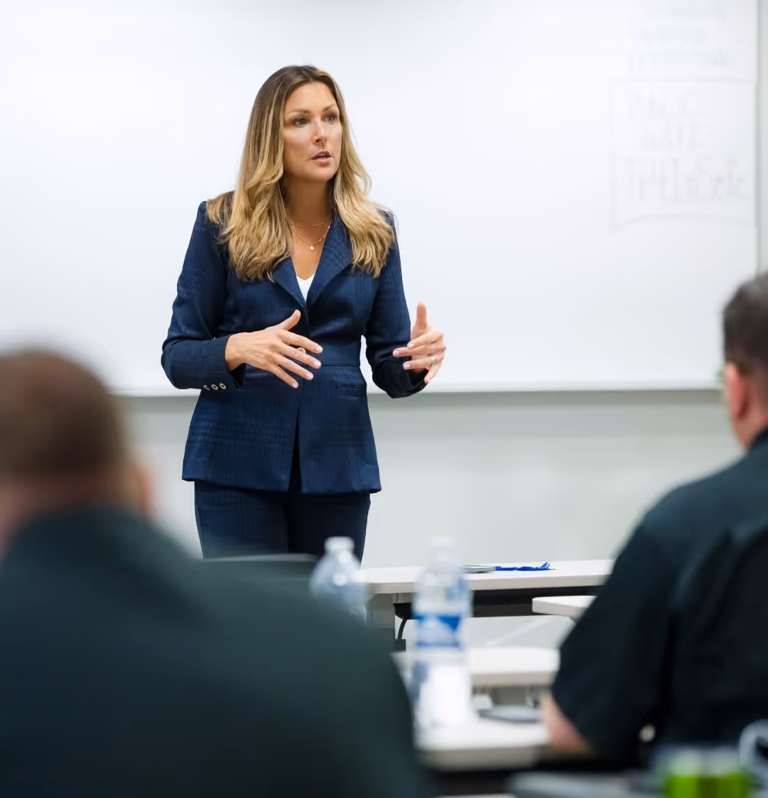 Image of Julie Parker giving a training presentation with a whiteboard behind her