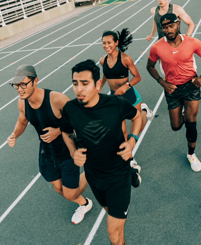 A group of people running on a track.