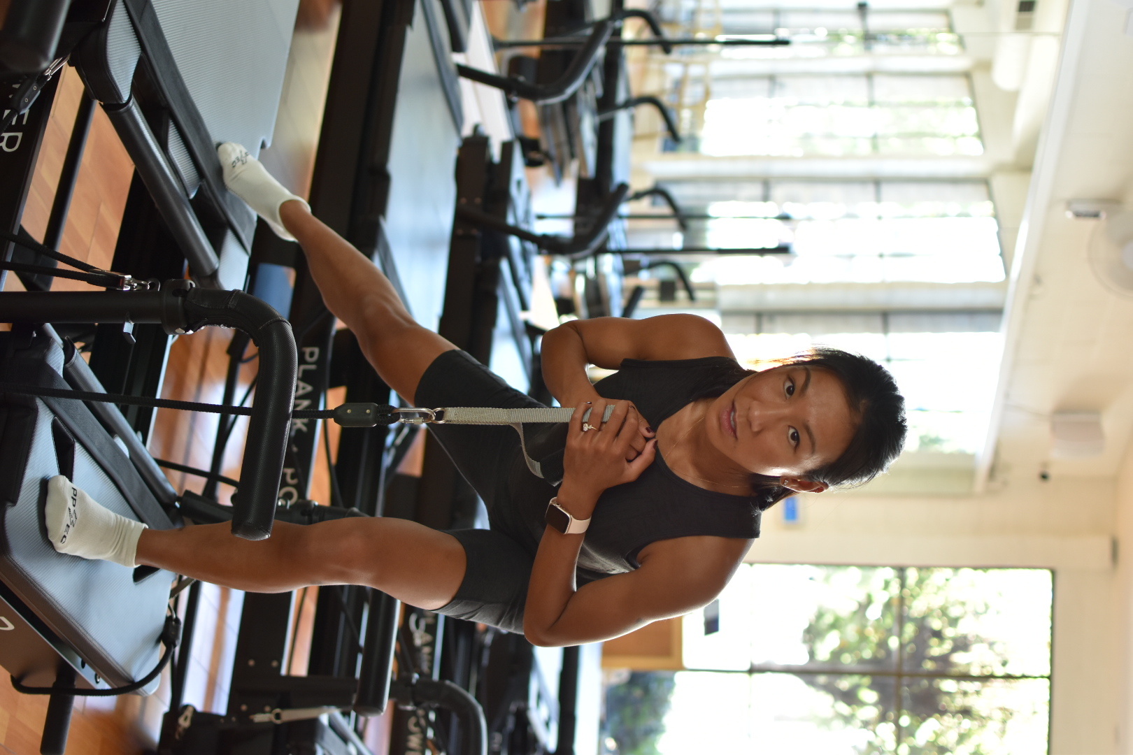 A woman is doing a workout in a gym.