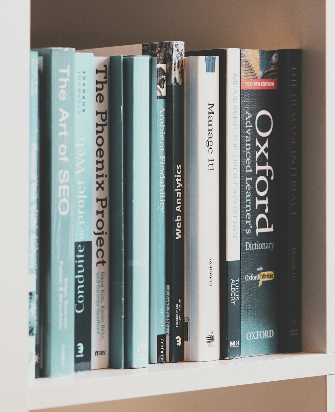 books on brown wooden shelf
