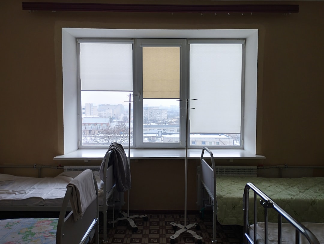 A room with two beds and a window