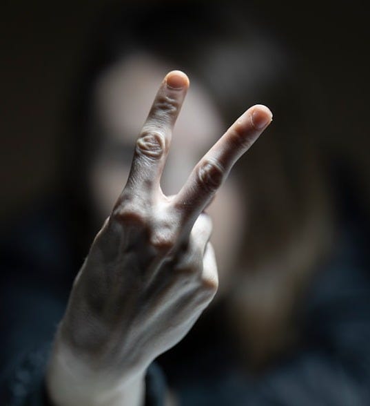 person in black long sleeve shirt showing right hand