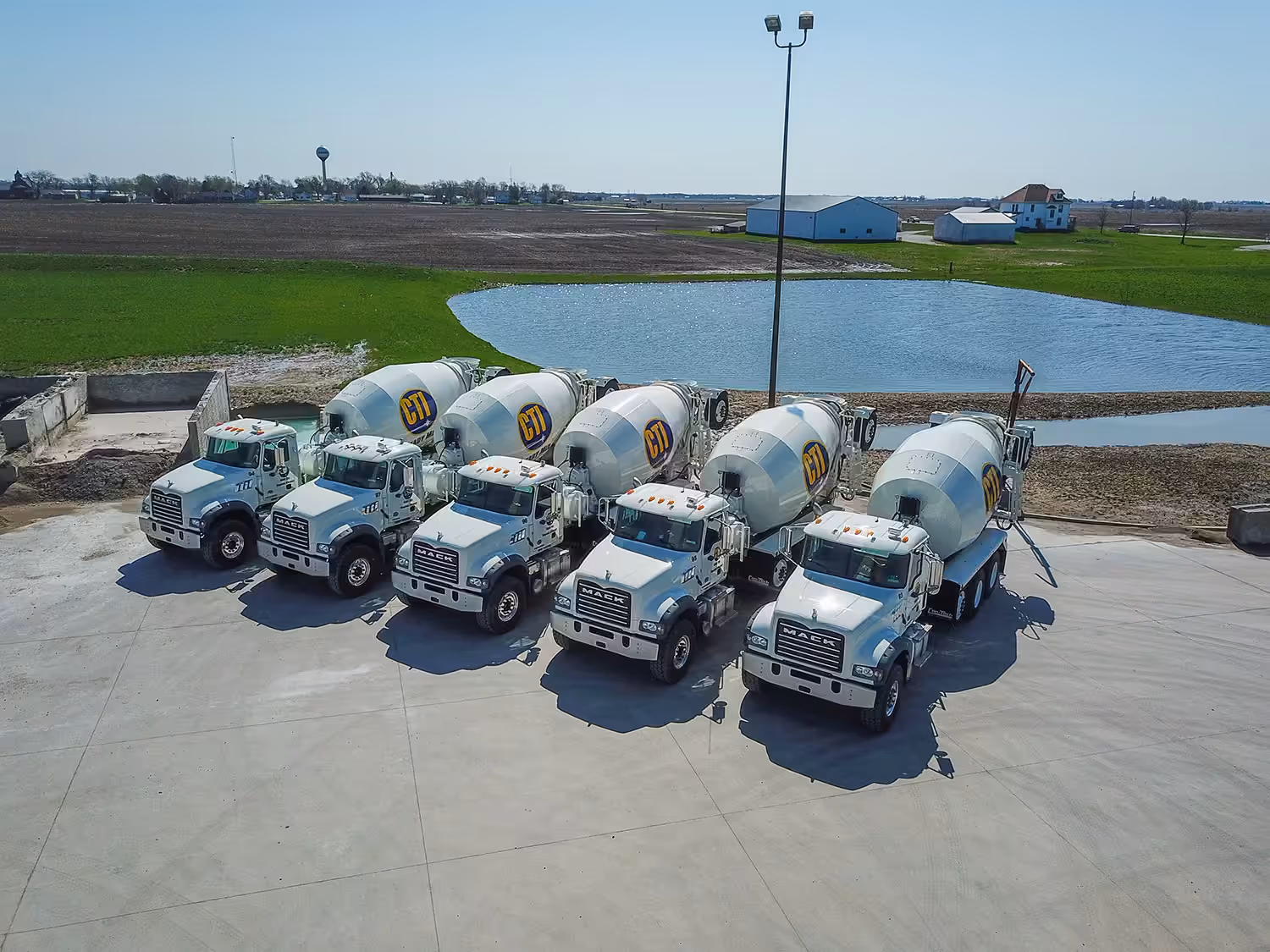 CTI Highly trusted concrete delivery trucks lined up in Grimes, Iowa at their Iowa concrete plant