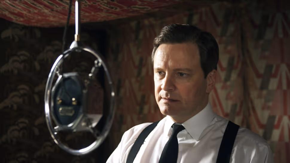 A light skinned person is standing in front of a microphone from the 1940s.