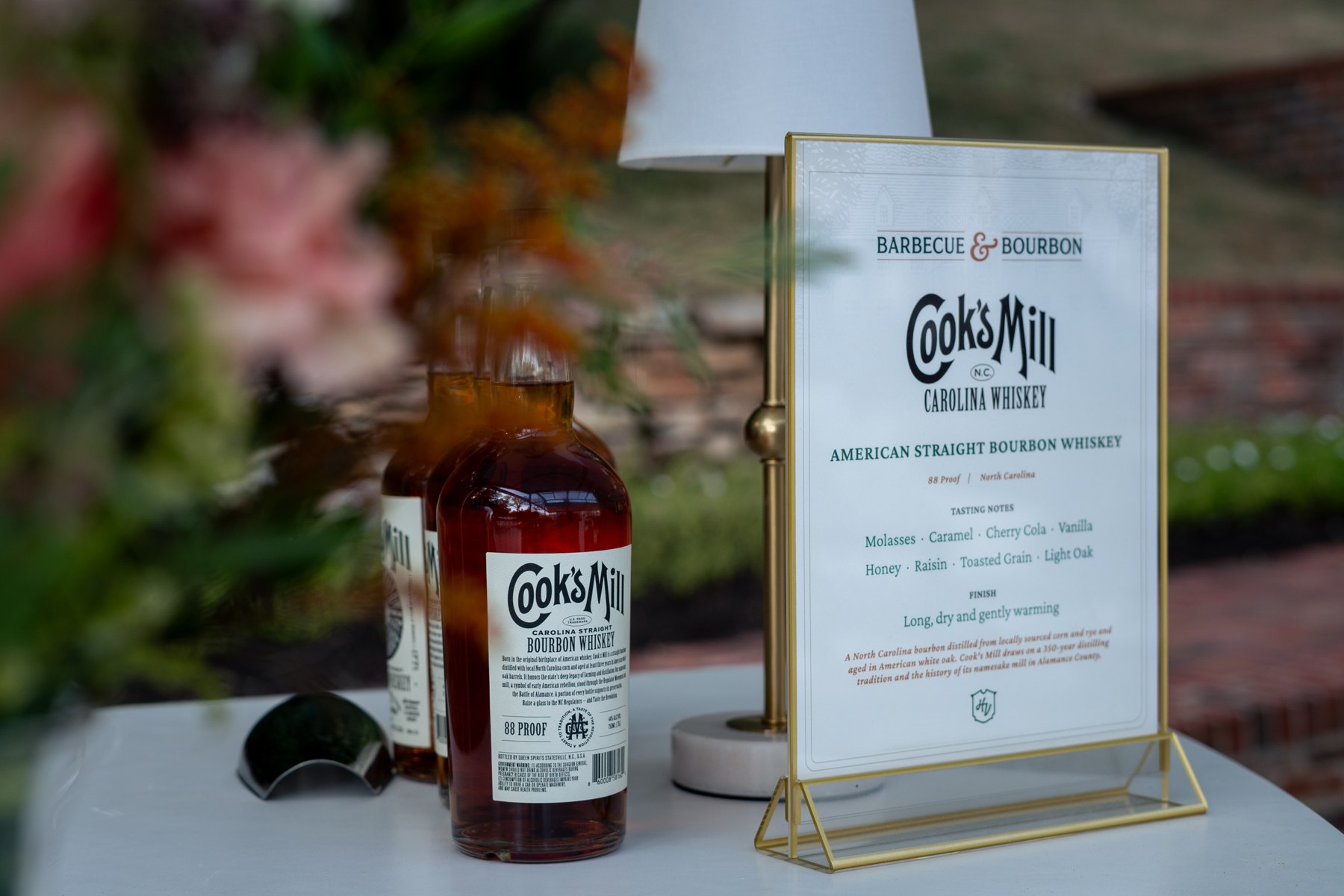 Cook’s Mill whiskey bottle and tasting sign at Barbecue & Bourbon