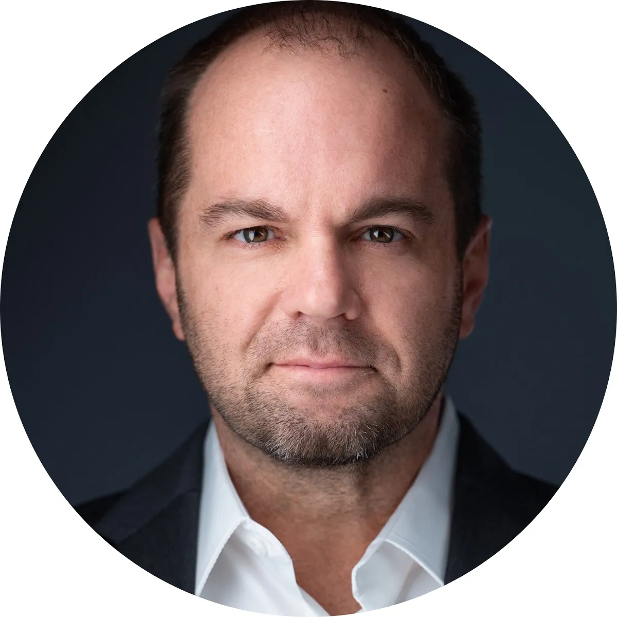 Entrepreneur and business advisor Nick Berry's headshot on a dark gray background.
